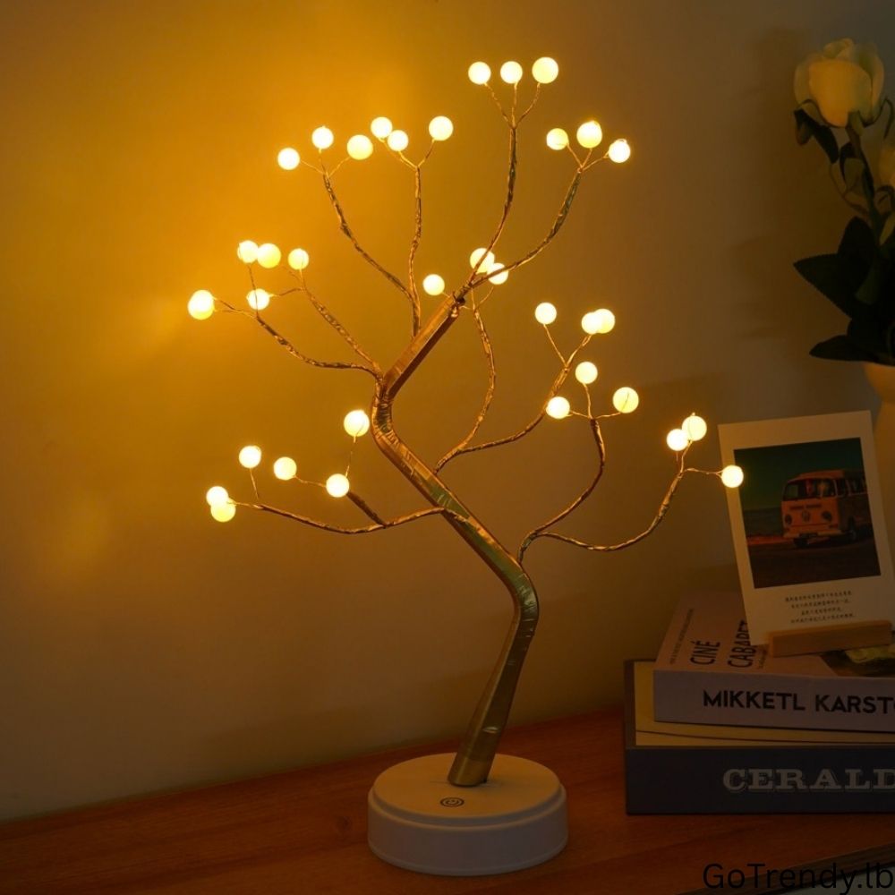 Bonsai Tree 36-LED lamp creating warm ambient lighting on a bedside table