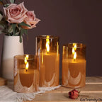 Three amber glass flameless LED candles with warm flickering light