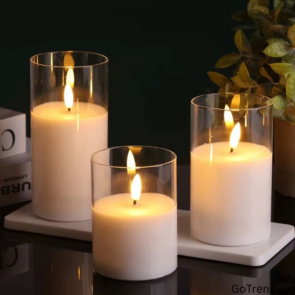 Three glass flameless LED candles glowing in a warm interior setting